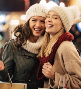 Two women enjoying holiday market